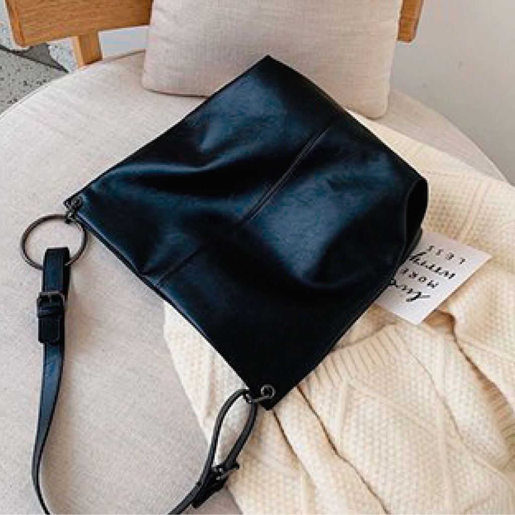 Black slouch shoulder bag with zip pocket and ring hardware