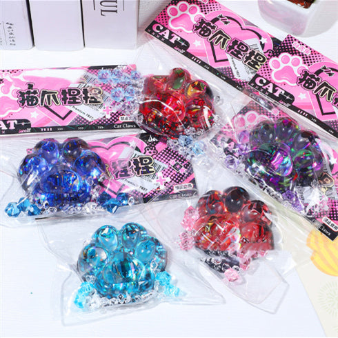 Glittery cat paw stress toy set with red, blue, and green paw shapes