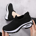 Women's black knit slip-on sneakers with air-cushion sole and thick tread