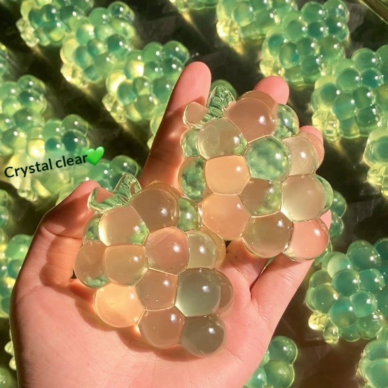 Transparent grape stress-relief toy, green and clear hex-tile fidget shape