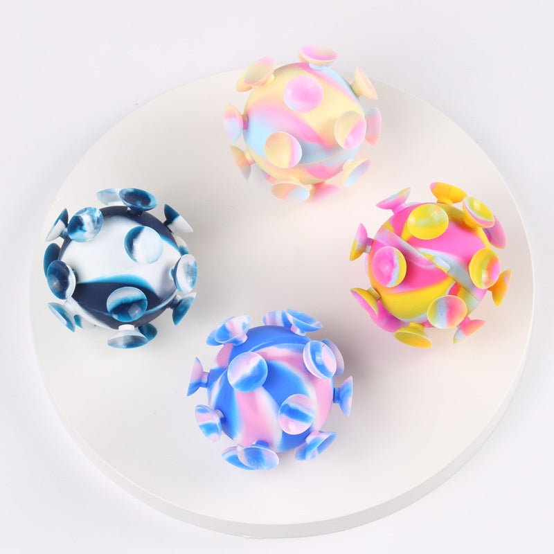 Tray of four 3D silicone stress balls: pastel, pink-yellow, blue, and dark blue