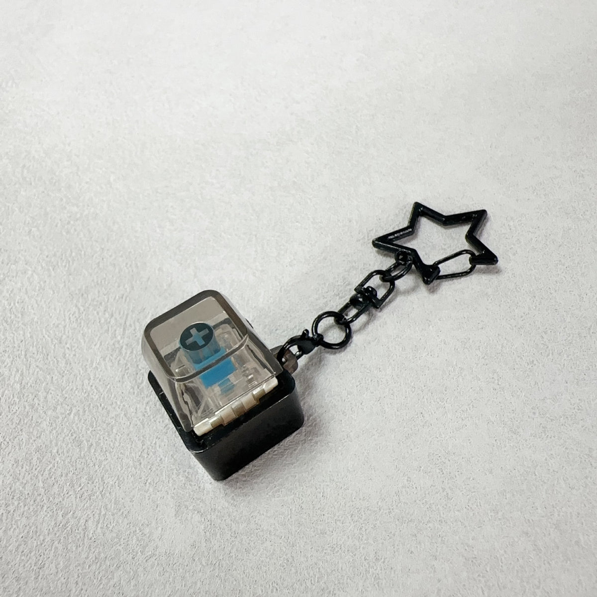 Black cube mechanical keyboard stress-relief keychain with star charm and chain link