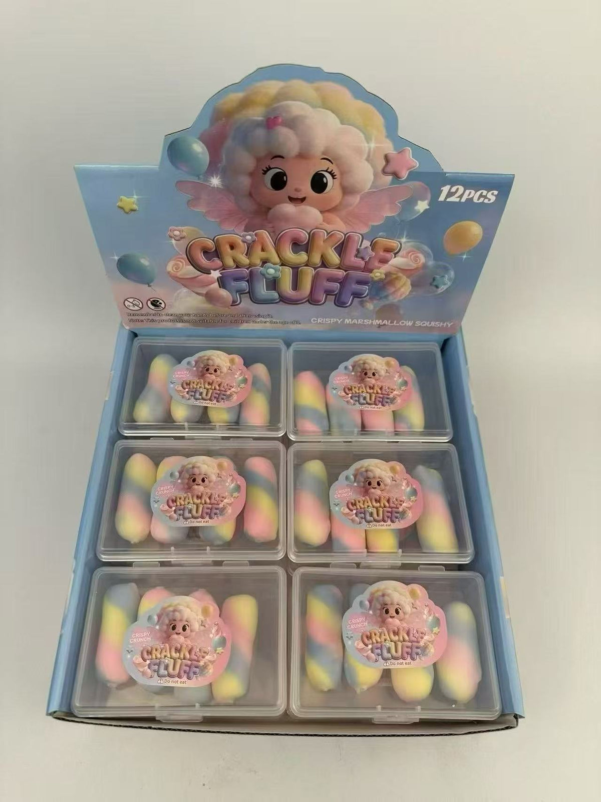 12-pack pastel chocolate squeeze toys in blue display box, featuring cracked-surface blocks