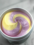 Body cream in white tub with swirled purple and yellow cream