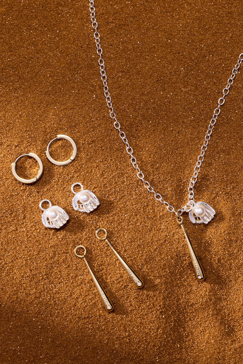 Two-tone pendant necklace with silver chain, helmet charms, and gold bat drop accents