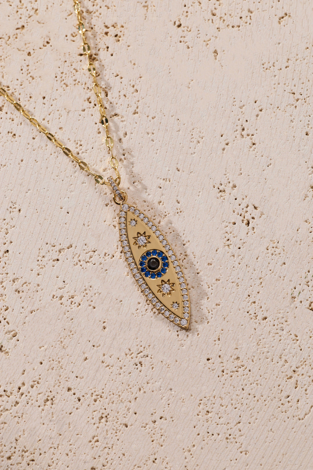 Gold marquise evil eye pendant necklace with blue enamel center on chain