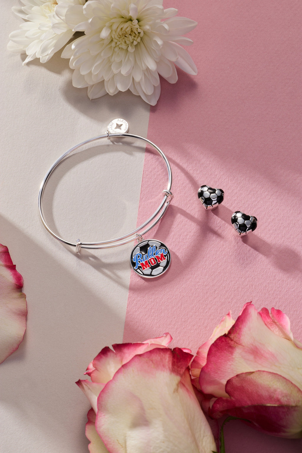 Two silver soccer ball heart stud earrings, black and white enamel