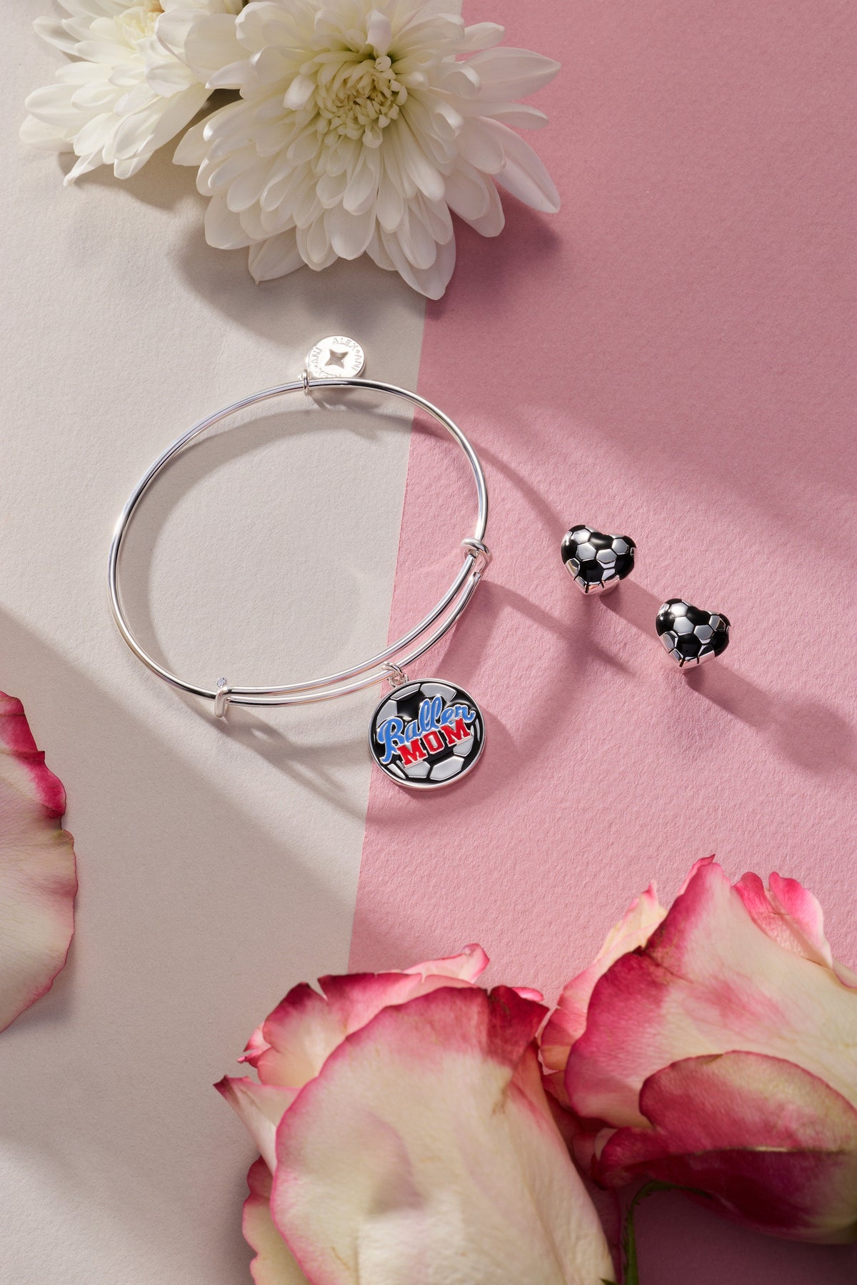 Two silver soccer ball heart stud earrings, black and white enamel