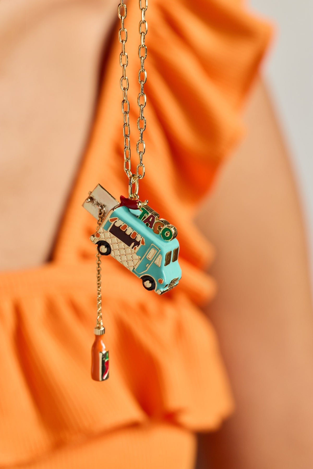 Gold taco truck locket necklace with taco truck pendant and small bottle dangle.