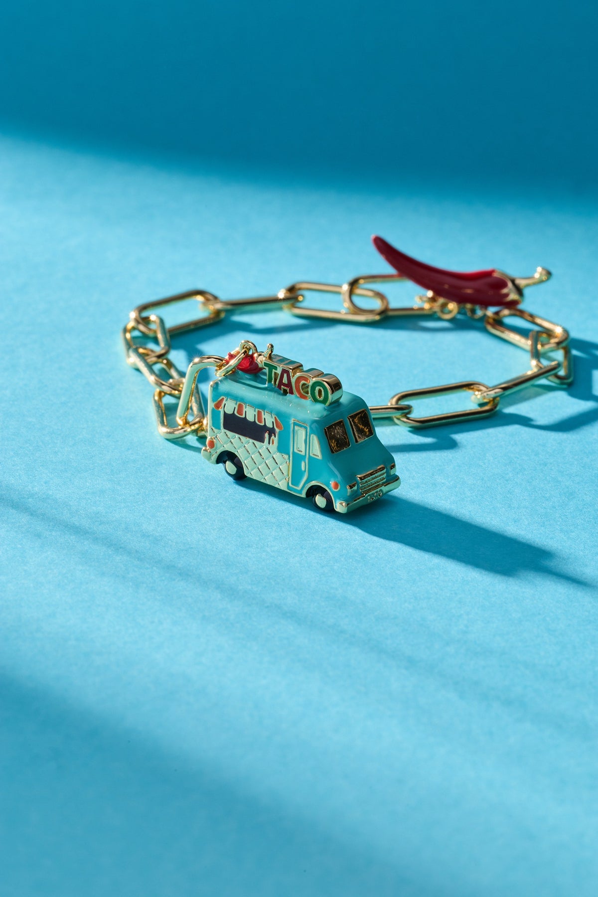 Gold taco truck toggle bracelet with red chili charm and linked frame