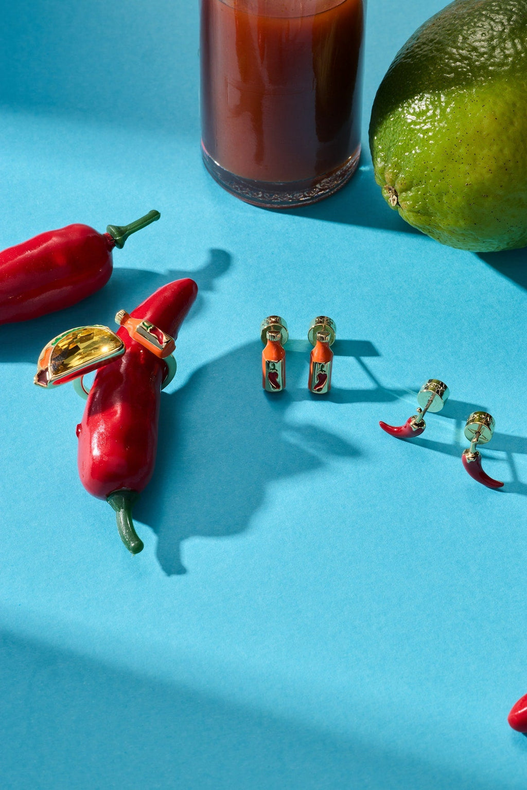 Hot sauce bottle and red chili pepper stud earrings, gold-tone posts shown