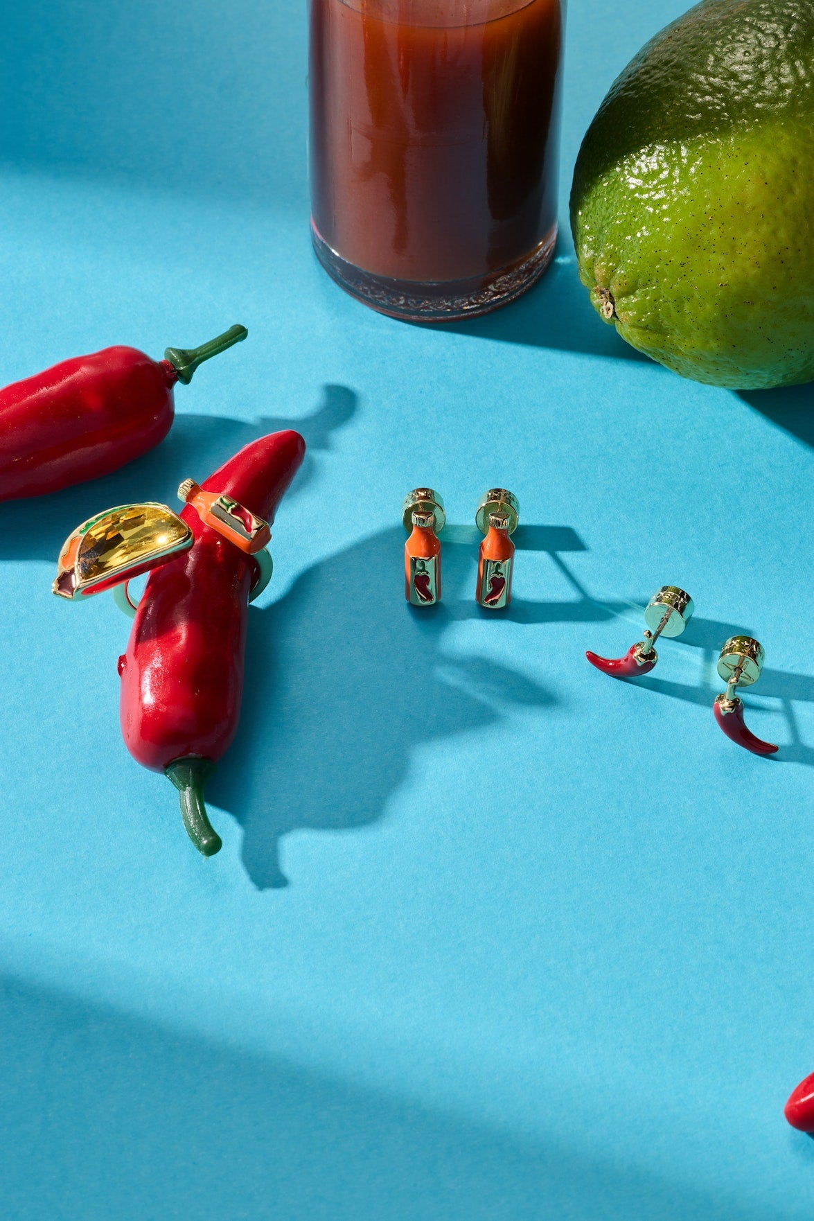 Hot sauce bottle and red chili pepper stud earrings, gold-tone posts shown