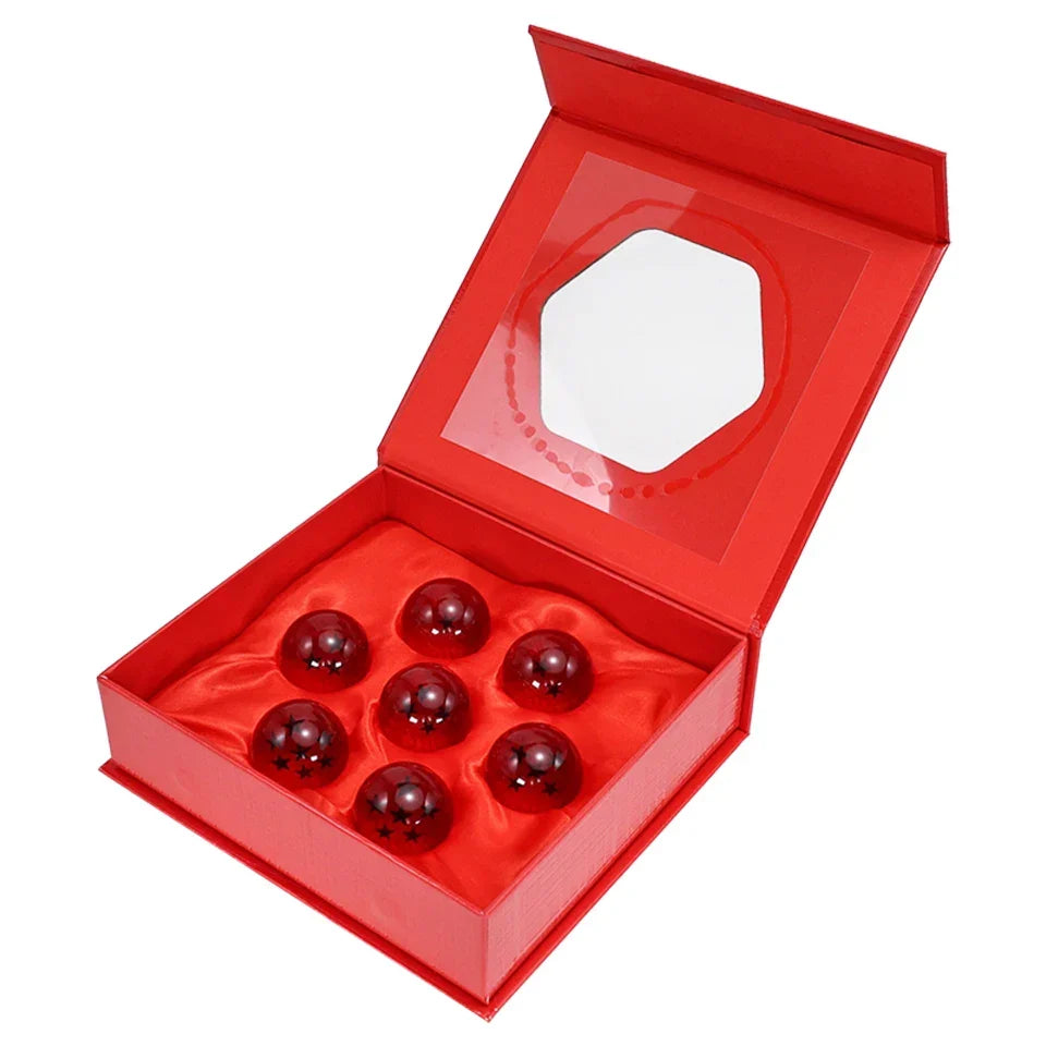 Open red gift box with seven red resin crystal globe spheres and black star emblems