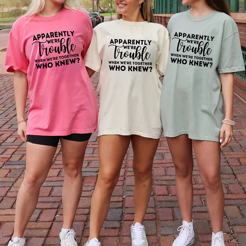 Pink bachelorette party T-shirt with 'Apparently we're trouble' front graphic