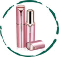 Rose-gold facial hair remover with protective cap, handheld device