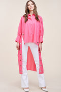 Oversized pink cotton shirt with button front, long sleeves, and ring detail