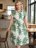 Green and white leaf print midi shirt dress with short sleeves and tied waist belt