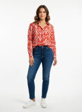 Red zebra print long-sleeve button-up shirt with collared neckline and front buttons