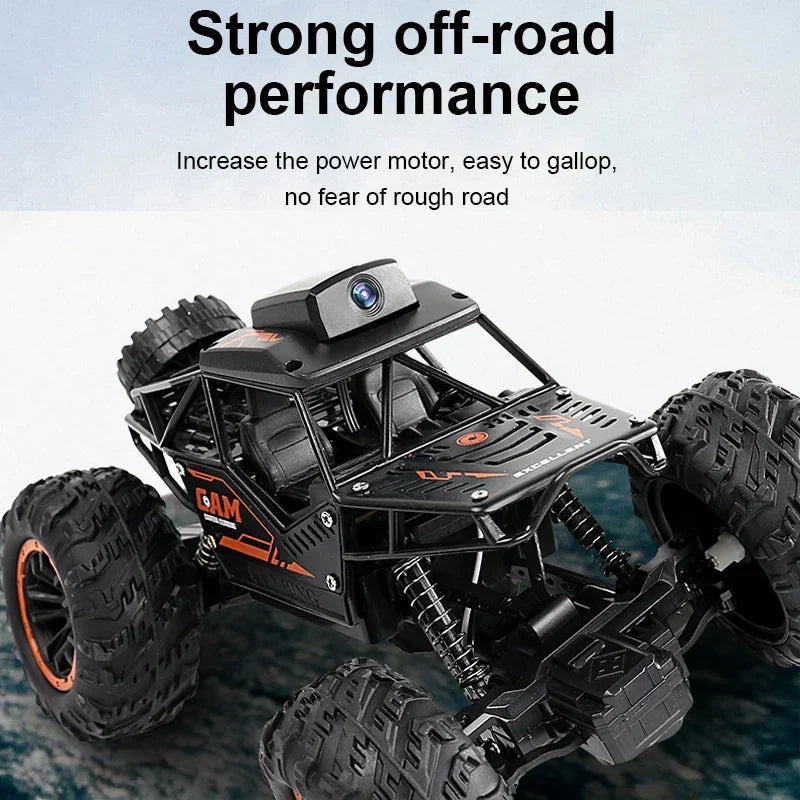RC stunt SUV with roof HD camera, black body with orange graphics and oversized off-road tires