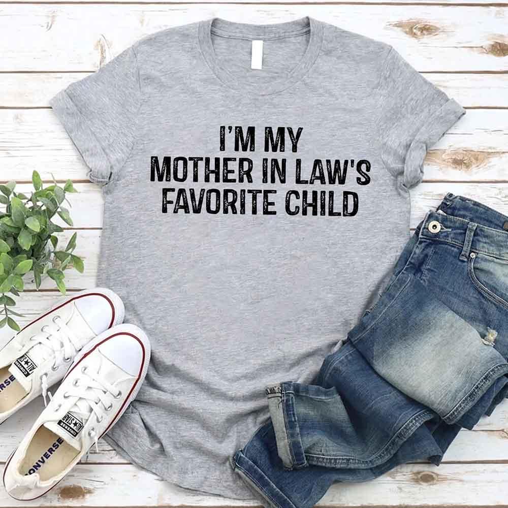 Grey crew-neck T-shirt with bold text “I’M MY MOTHER IN LAW’S FAVORITE CHILD”.