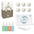 Laundry care bundle with six white wool dryer balls, detergent sheets, and essential oil bottles