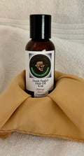 Black hair oil bottle with white label on folded cloth