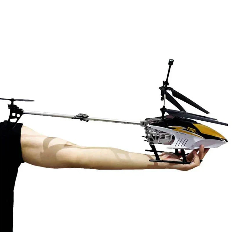 RC helicopter drone held in hand, white and yellow body with black rotor