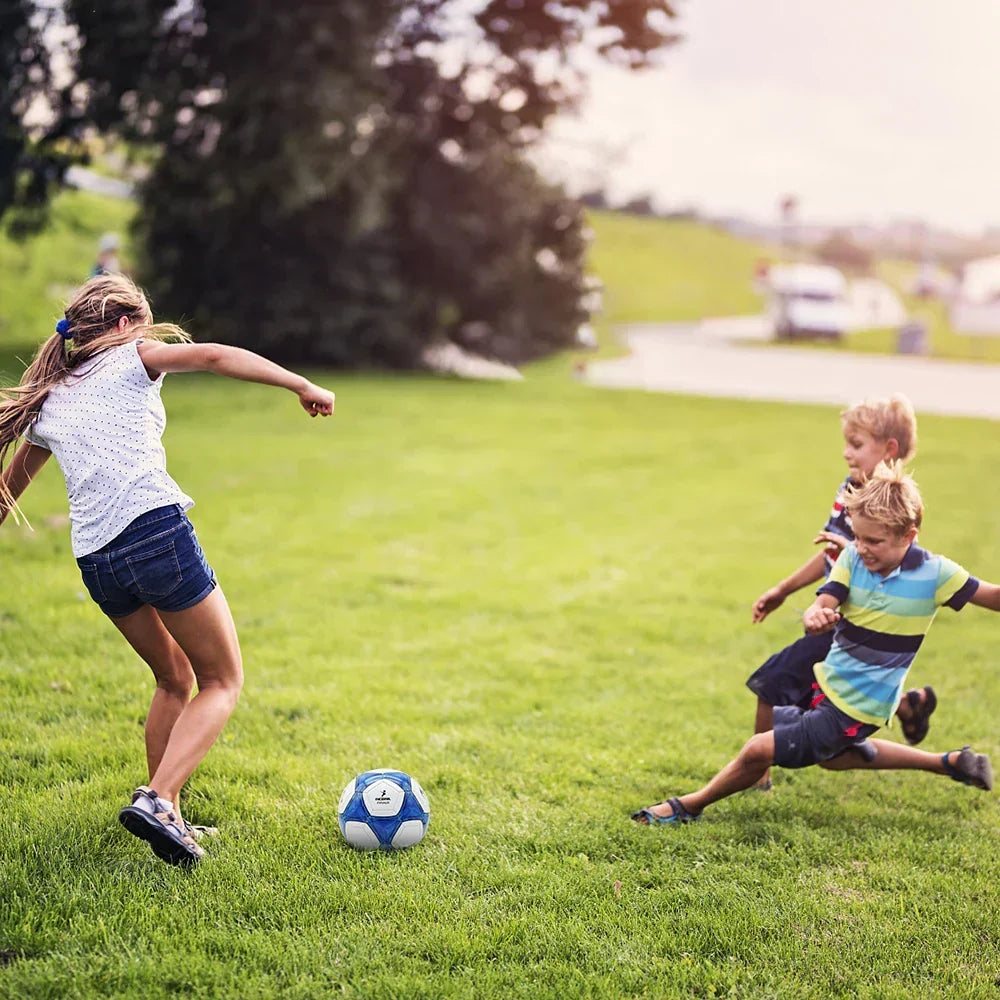 Youth size 5 soccer ball on a lawn, white and blue machine-stitched panels