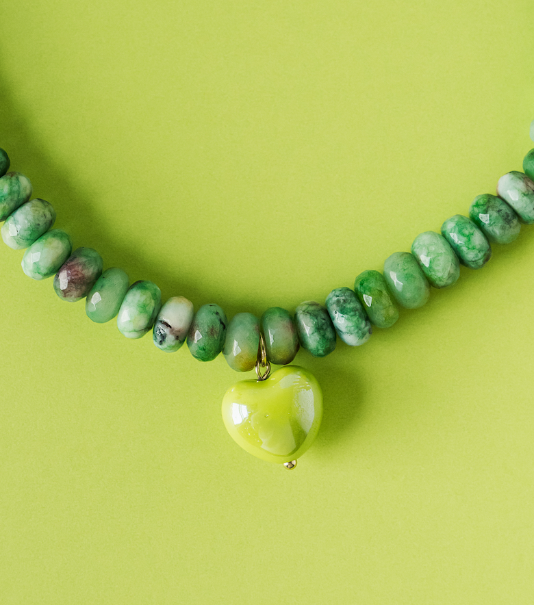 Green beaded necklace with small heart pendant and gold-tone chain