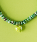 Green beaded necklace with small heart pendant and gold-tone chain
