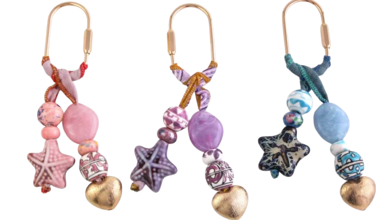 Bag charms set with starfish, shell and bead ornaments on metal hooks