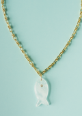 Gold fish pendant necklace with white translucent fish charm on gold chain.