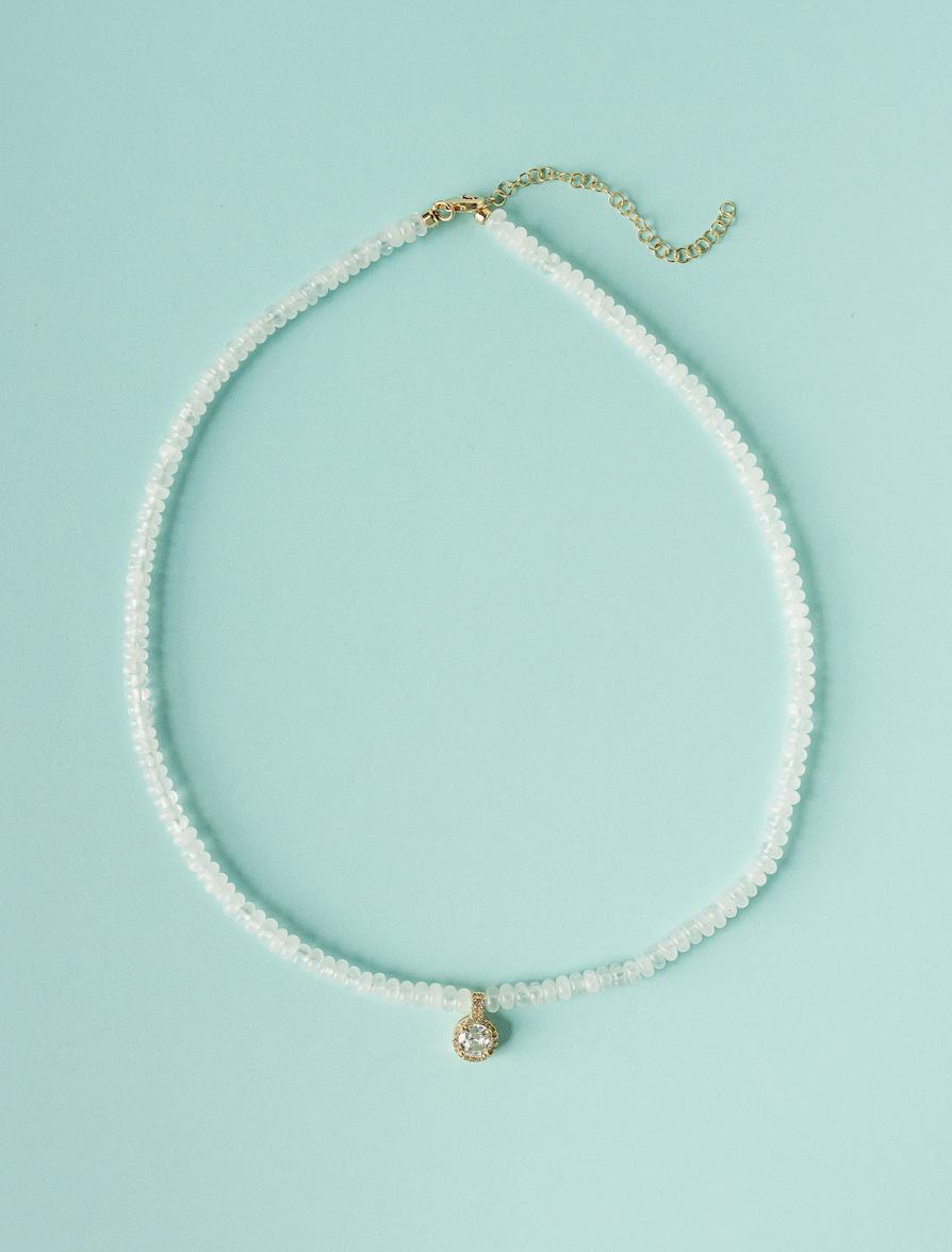 White beaded necklace with round charm pendant and gold-tone clasp