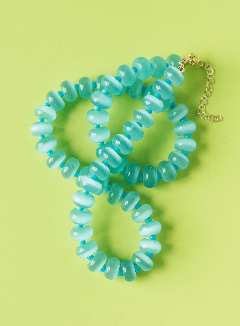 Aqua bead necklace with gold-tone chain and lobster clasp, shown in layered loop