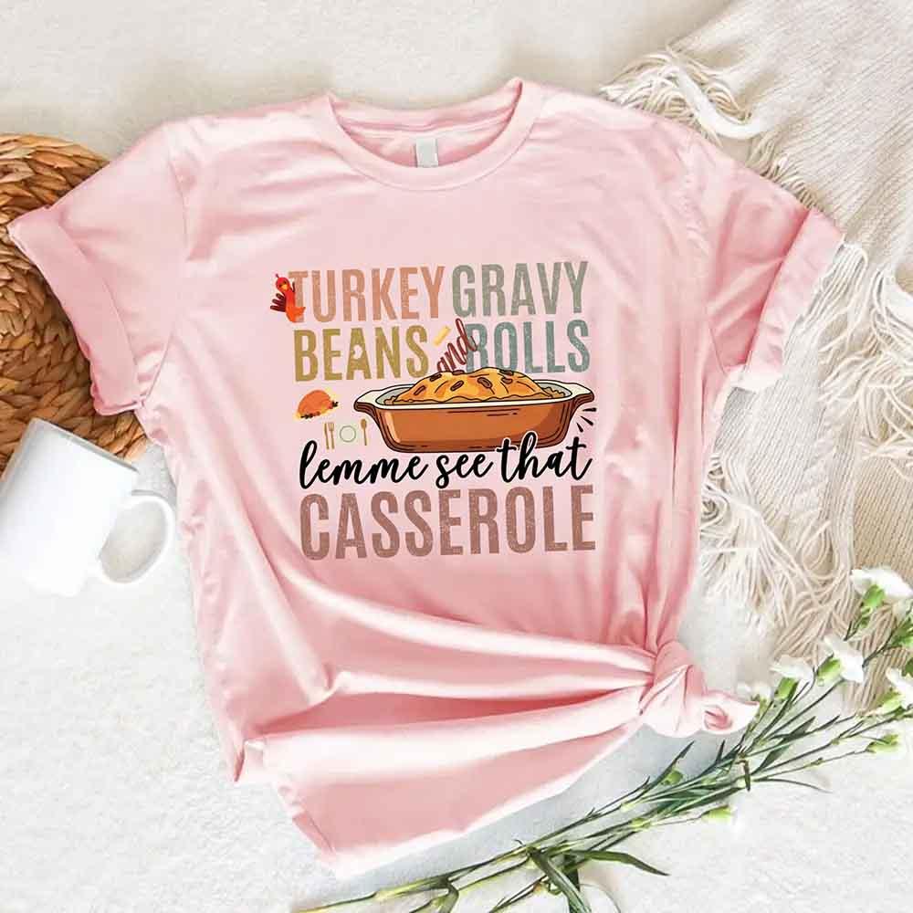 Soft pink crewneck T-shirt with turkey gravy beans and casserole graphic on chest