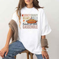 White crew-neck Thanksgiving graphic T-shirt with “casserole” slogan and dish illustration
