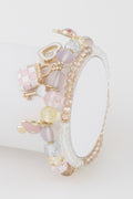 Bead charm bracelet with pastel pink beads and gold-tone charms