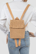 Khaki woven mini backpack worn on back with tan adjustable straps