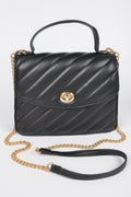 Black quilted top handle flap bag with gold clasp and chain strap, front view.