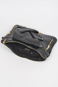 Black faux leather novelty bag corner view with gold zipper trim and chain handles