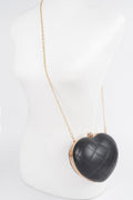 Black quilted heart crossbody bag with gold-tone chain strap and clasp closure.