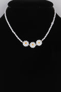 Beaded flower necklace with three white daisy charms on a pearl-toned bead chain