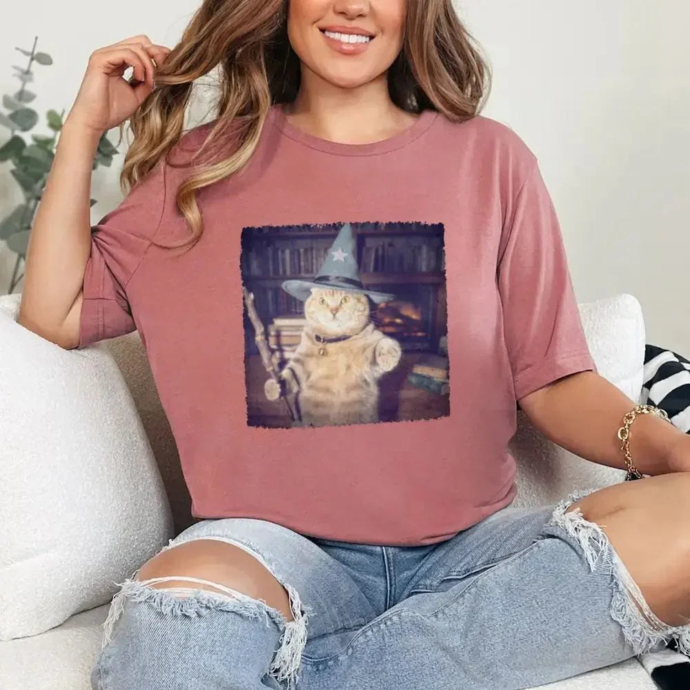 Mauve/purple cat wizard graphic T-shirt with a square illustrated cat print on chest.