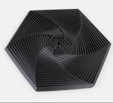 Hexagon sensory fidget toy in black with concentric ridges and central spiral detail