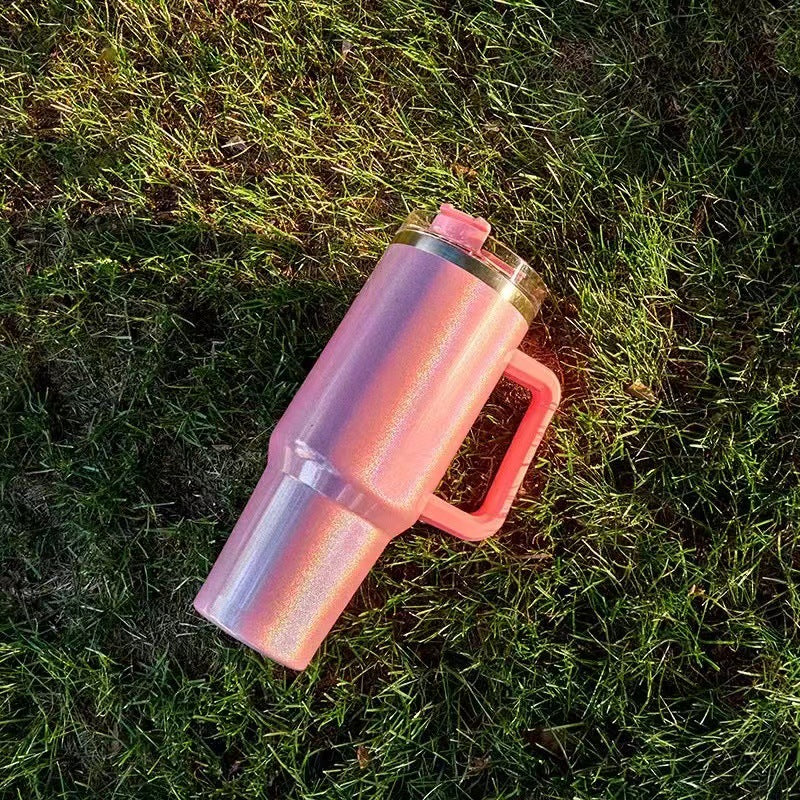 Large insulated stainless steel tumbler with iridescent pink-purple finish, clear lid, straw, handle