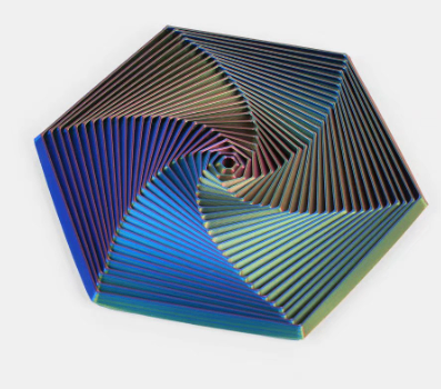 Hexagon sensory fidget toy with blue and brown spiral ridges and a dark concentric core.
