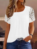 White short-sleeve blouse with lace cutout sleeves and gathered neckline, close side view