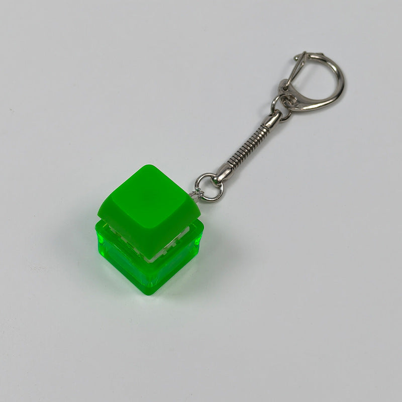 Green cube stress-relief keychain toy with finger-popping button and metal chain