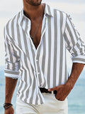 Striped button-up shirt in light blue and white, long sleeves with cuffs and open collar