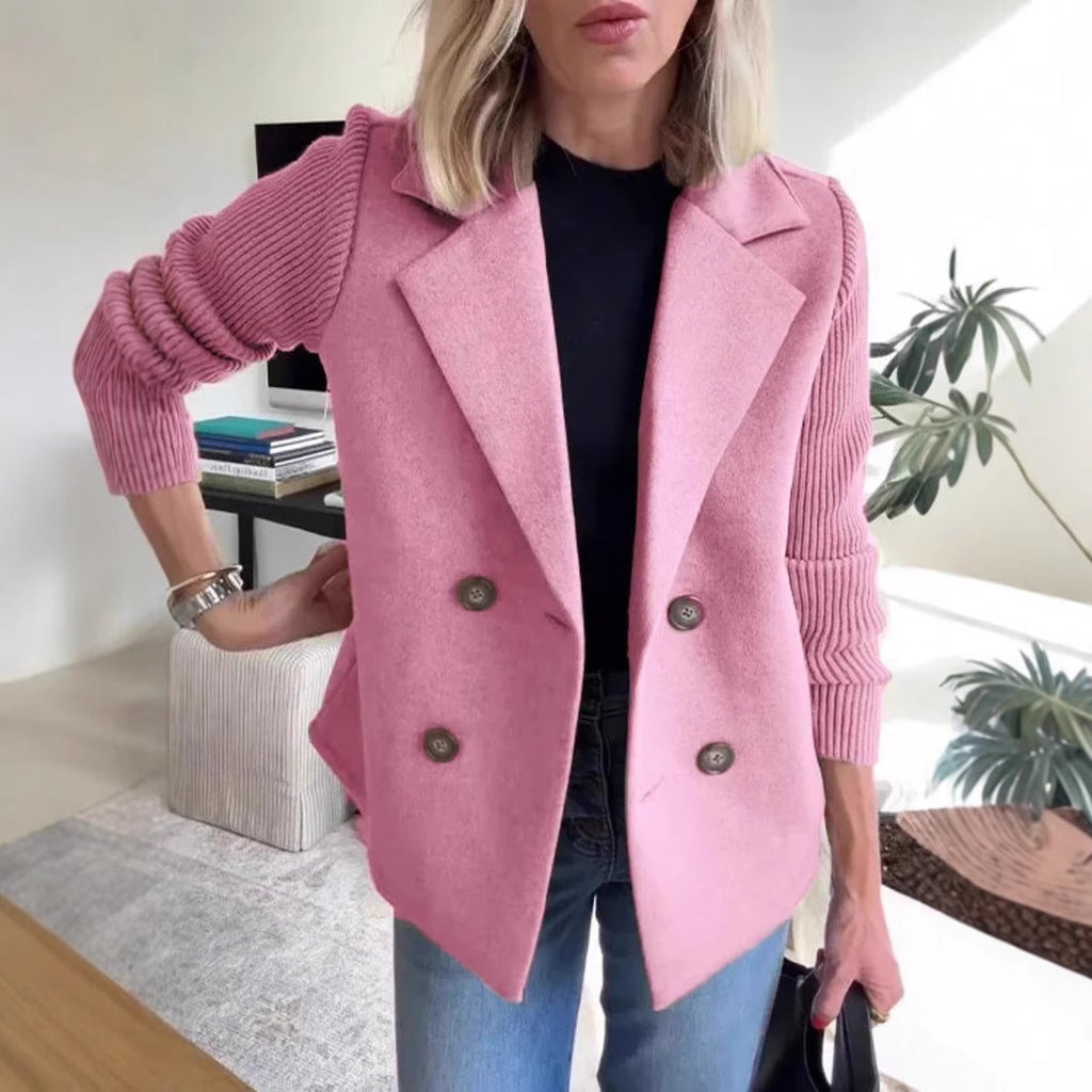 Pink double-breasted lapel jacket with ribbed knit sleeves and four dark buttons.